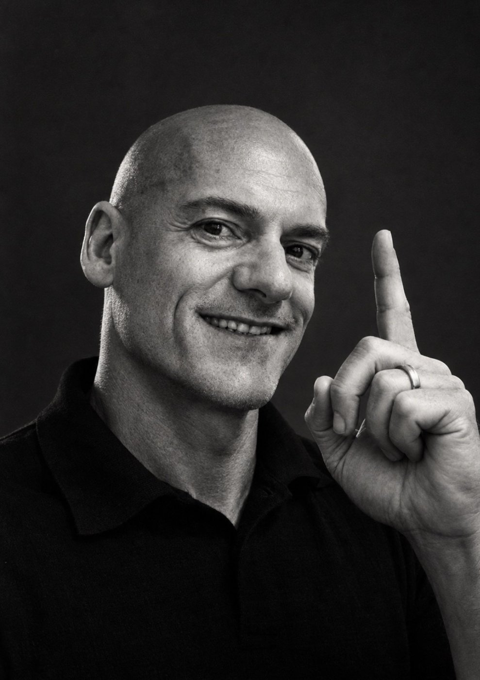 Portrait of Dr Edoardo Cervoni, MD, smiling and raising a finger